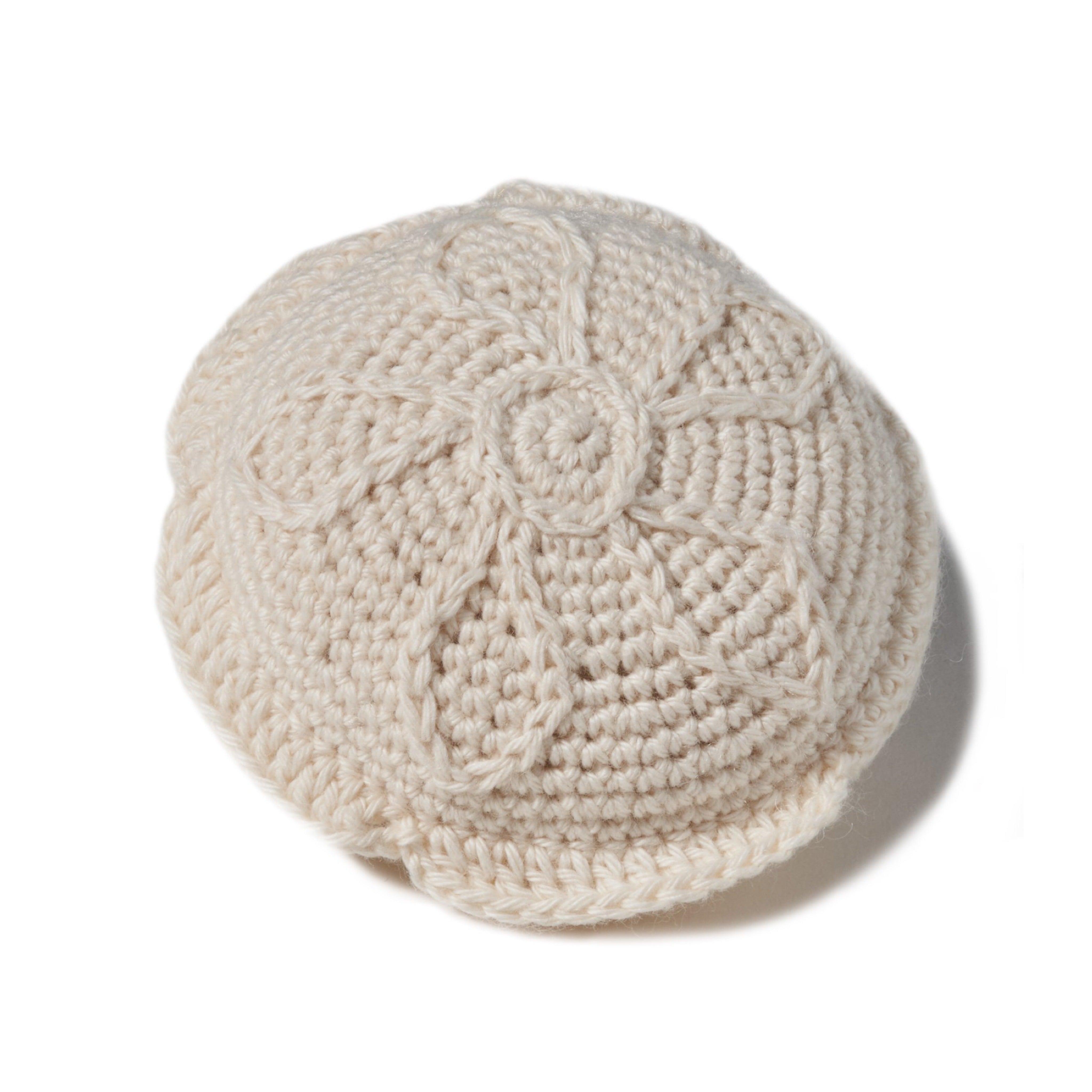 natural organic soft toy in the shape of a sand dollar with a rattle inside and at 4" in diameter.. 100% organic cotton hand crochet knit.