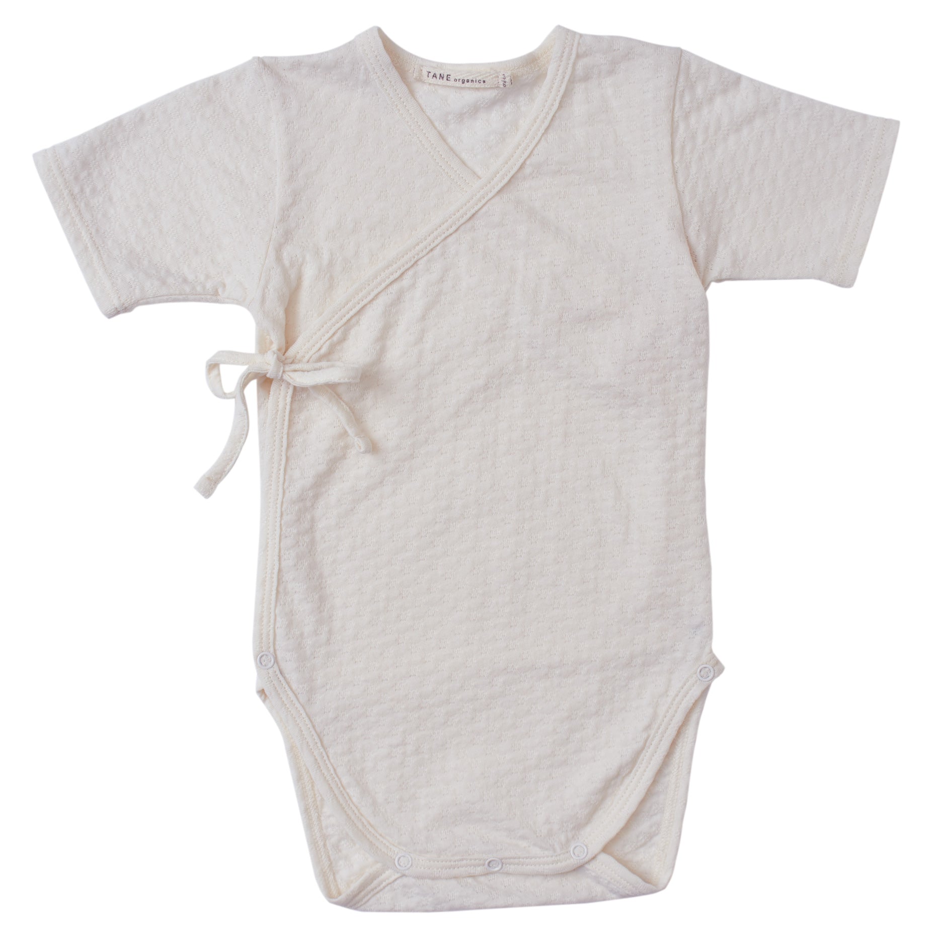 cream color pointelle short sleeved double front kimono wrap onesie.  100% organic cotton.