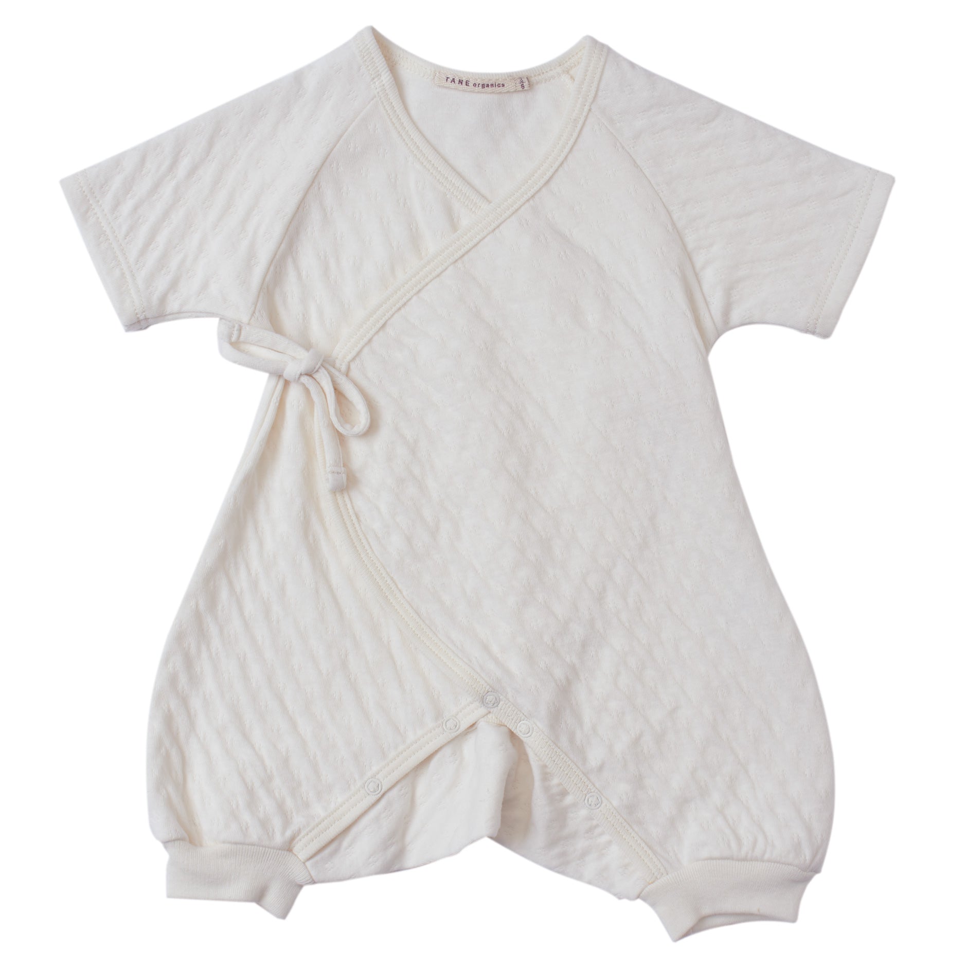 cream color pointelle short sleeved kimono double front wrap onesie with leggings.  100% organic cotton.