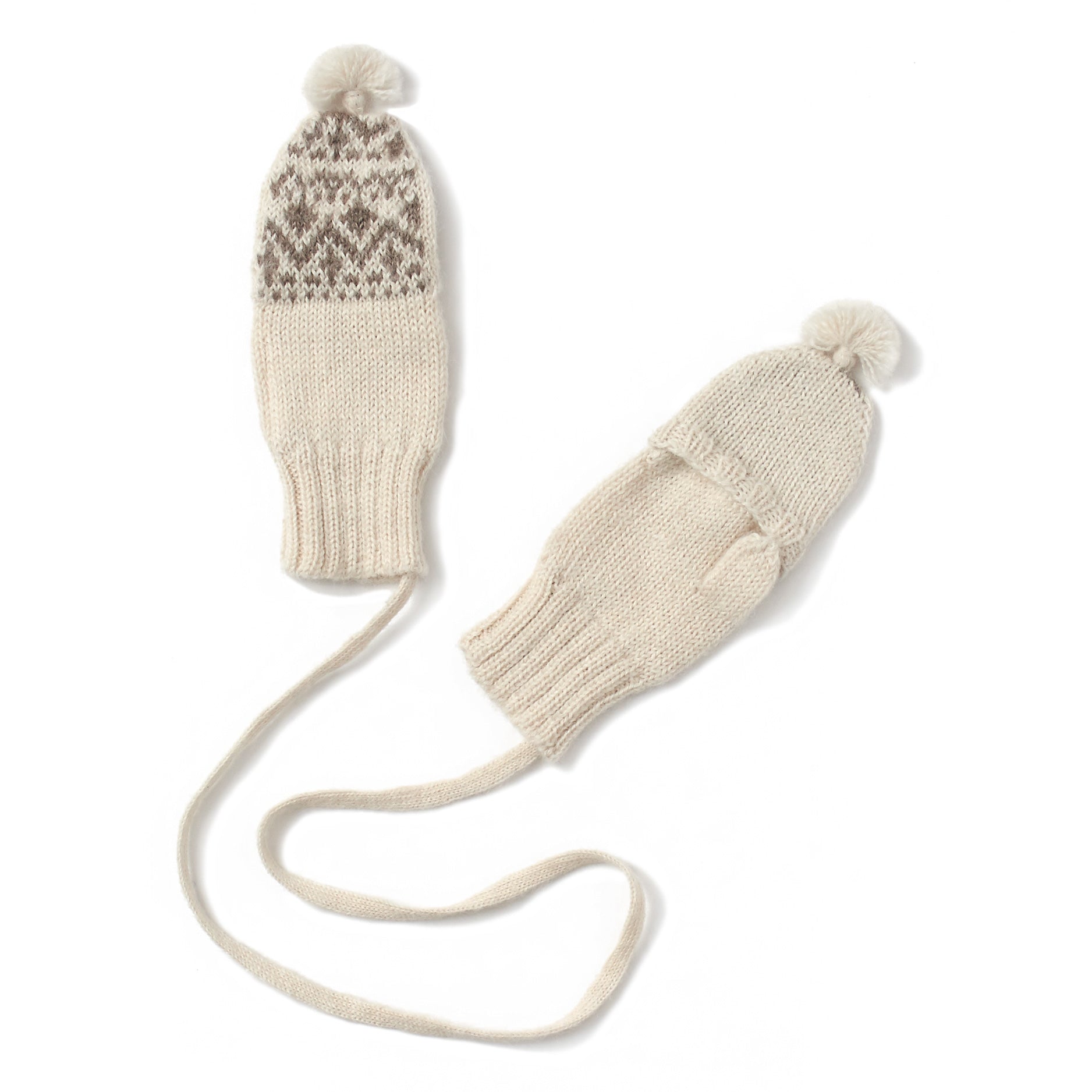 soft white mittens knitted in fair isle pattern, string attached together, tassel on top, fingerless with flap cover, handmade in 100% baby alpaca