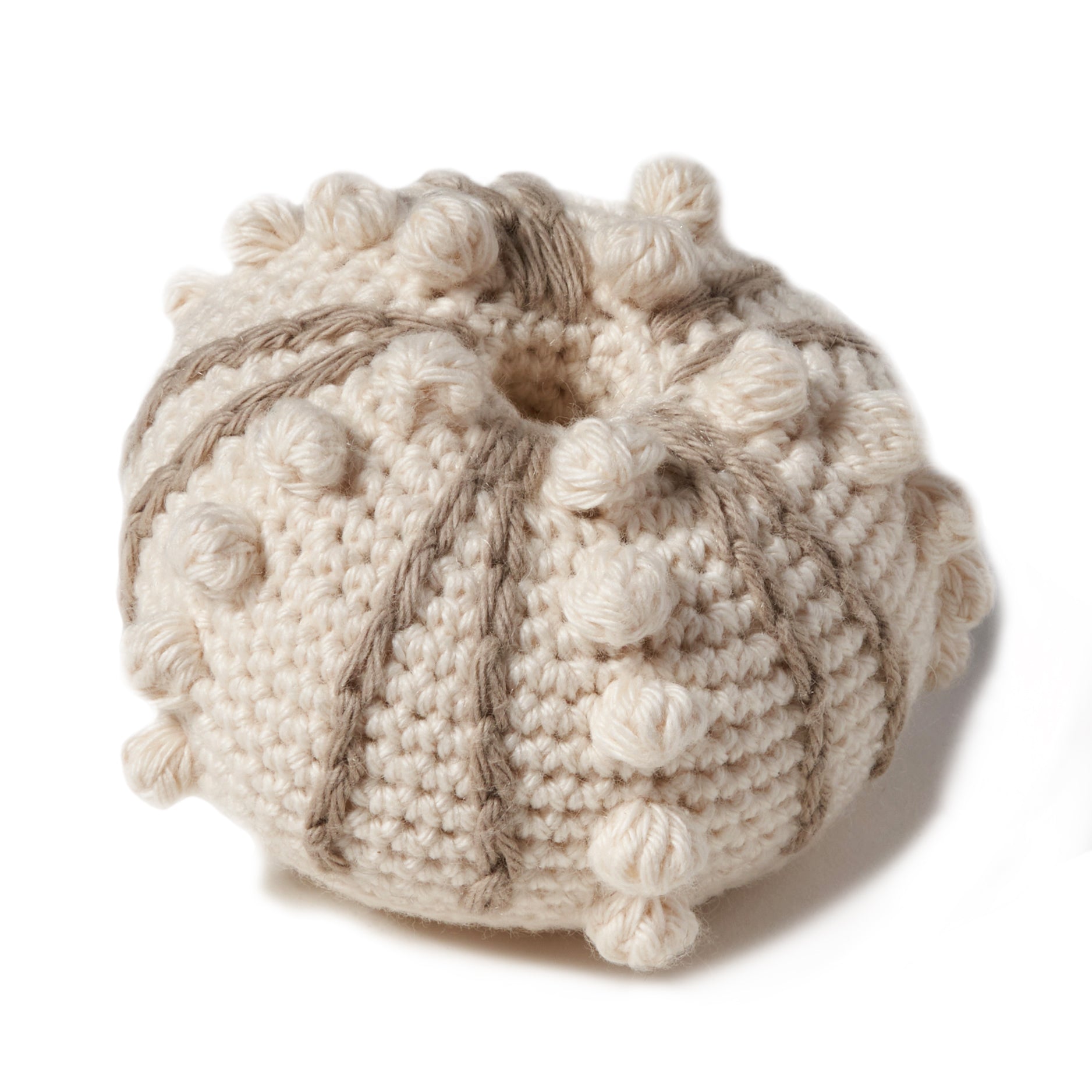 natural organic soft toy in the shape of a sea urchin with a rattle inside and at 3 1/2" in diameter..  100% organic cotton hand crochet knit.